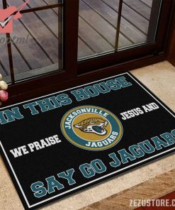 In this house we praise jesus and say go Jaguars doormat